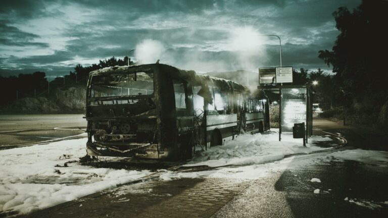 Burnt bus at a desolate bus stop captured at night for Website SEO audit