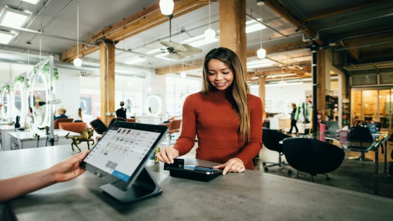 Customer using a mobile-optimized payment system in a modern store setting