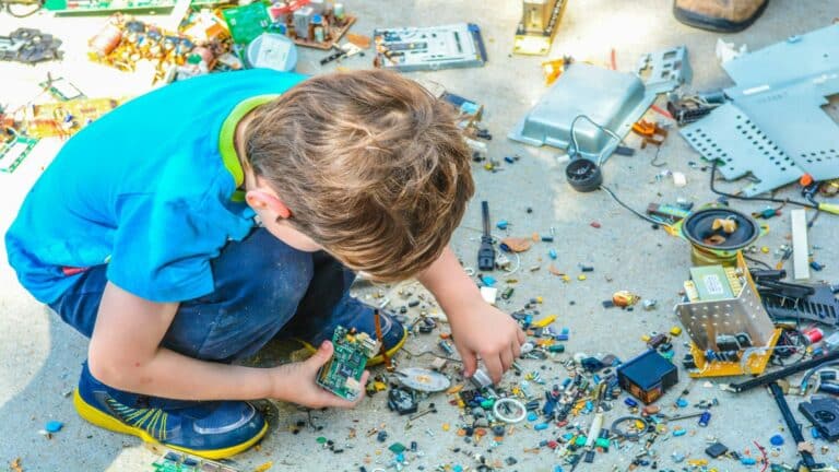 Child examining electronic components related to search engine marketing