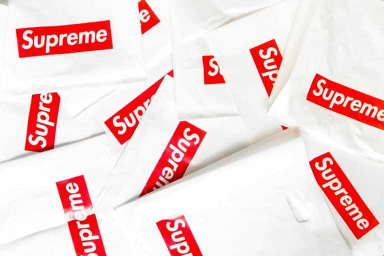 Supreme branded content marketing services with white and red logo bags