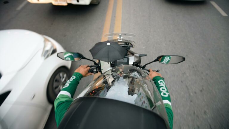 Motorcycle delivery rider navigating traffic in London with a focus on Web Design London services