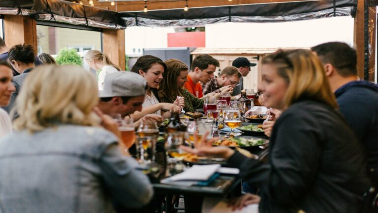 A group of people dining together, showcasing collaboration and creativity, representing web design examples in London.