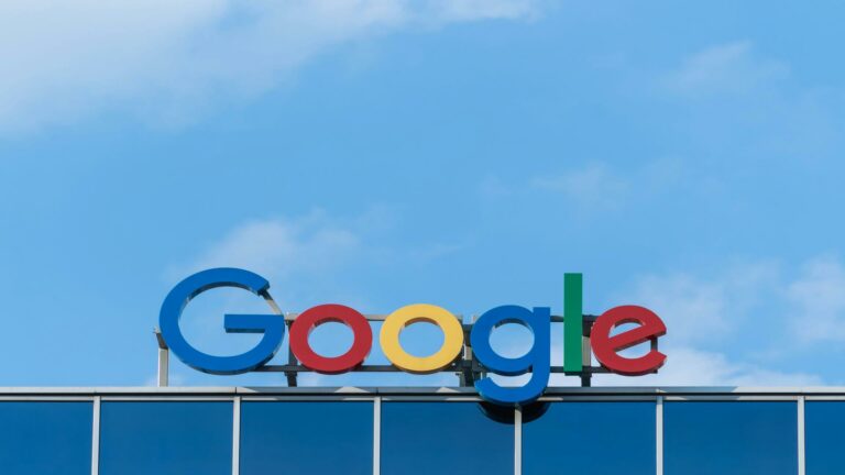 Google logo on office building under a clear blue sky