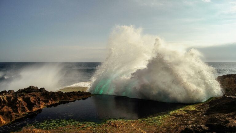 Powerful ocean wave crashing against rocky shore captured by Web Design London