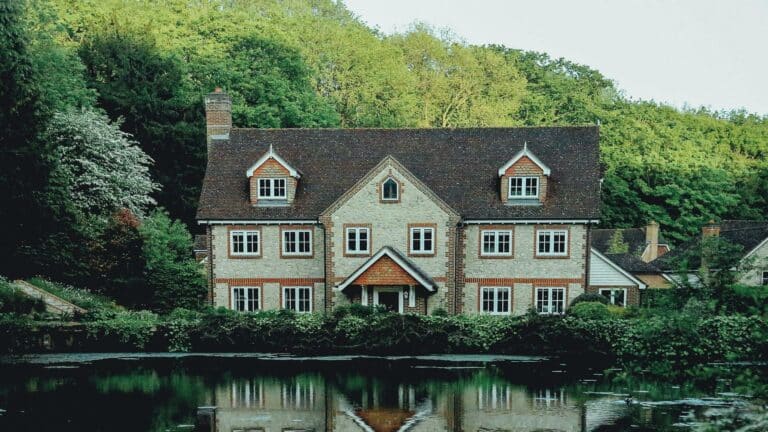 Charming countryside home surrounded by greenery and a serene lake, ideal for showcasing web design London expertise