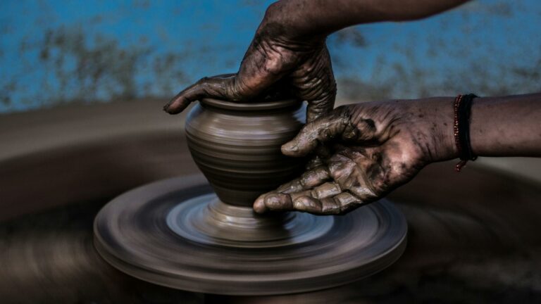 Hands shaping clay on a pottery wheel, symbolizing creativity and content marketing tools