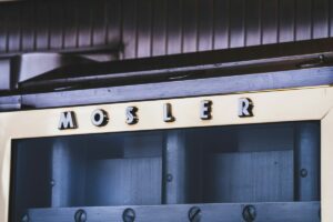Vintage Mosler security cabinet showcasing classic business design with metal lettering on cream-colored frame